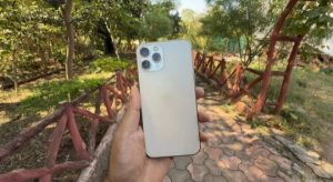 IPhone 12 pro max smartphone in my hand with beautiful nature background 