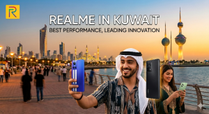 ​An advertising banner image for realme phones in Kuwait, featuring a group of friends taking a selfie on a vibrant corniche with the iconic Kuwait Towers in the background during sunset. The realme logo and tagline "REALME IN KUWAIT, BEST PERFORMANCE, LEADING INNOVATION" are prominently displayed. The friends are holding realme smartphones. This image promotes the brand's presence and appeal in Kuwait