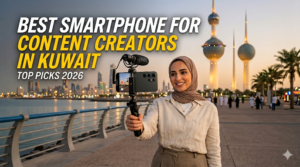 A woman in a hijab filming a vlog with a phone attached to a tripod and a Rode microphone, with the Kuwait Towers in the background. The text overlay reads, Best Smartphone for Content Creators in Kuwait - TOP PICKS 2026
