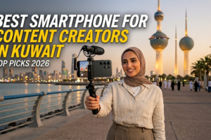 A woman in a hijab filming a vlog with a phone attached to a tripod and a Rode microphone, with the Kuwait Towers in the background. The text overlay reads, "BEST SMARTPHONE FOR CONTENT CREATORS IN KUWAIT - TOP PICKS 2026