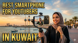 A YouTube thumbnail with the text BEST SMARTPHONE FOR YOUTUBERS IN KUWAIT The image features a smiling woman in a hijab vlogging outdoors on a coastal promenade, holding a premium smartphone mounted on a gimbal stabilizer. In the background, the iconic Kuwait Towers stand tall against a scenic sunset sky with boats on the water.
