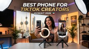 A young female content creator smiling and filming a video using smartphones with ring lights on tripods in a studio setup, featuring the Kuwait Towers in the background window, text overlay reading Best Phone for TikTok Creators in Kuwait 2026