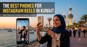 A promotional image features a woman in a blue hijab filming herself on a smartphone for Instagram Reels against the backdrop of Kuwait City towers. The text overlay reads 'THE BEST PHONES FOR INSTAGRAM REELS IN KUWAIT' with the subtitle 'Top Picks for Content Creators (2026).' The image is an informative graphic identifying the Best Phone for Instagram Reels in Kuwait for content creators