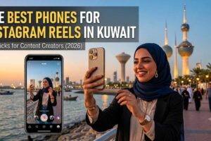 A promotional image features a woman in a blue hijab filming herself on a smartphone for Instagram Reels against the backdrop of Kuwait City towers. The text overlay reads 'THE BEST PHONES FOR INSTAGRAM REELS IN KUWAIT' with the subtitle 'Top Picks for Content Creators (2026).' The image is an informative graphic identifying the Best Phone for Instagram Reels in Kuwait for content creators